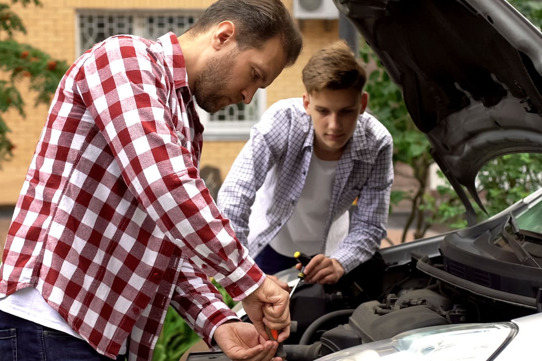 dad-teaching-teen-son-how-to-repair-car