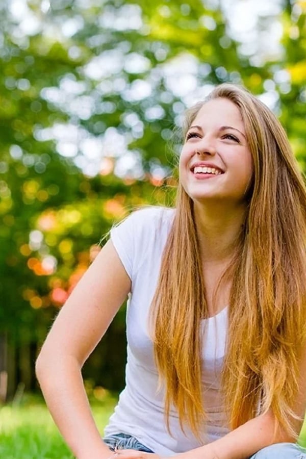 female-teen-outdoors-smiling-VERTICAL