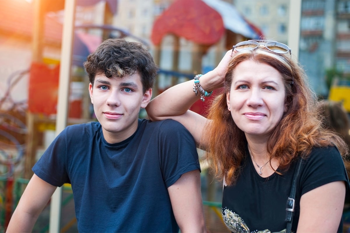 mom-and-son-at-on-bench-at-public-event