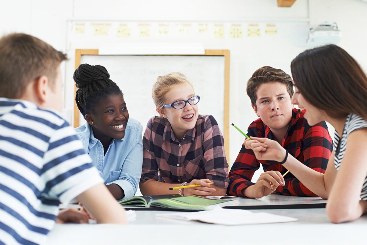 teen-students-collaborating-on-project-in-classroom_