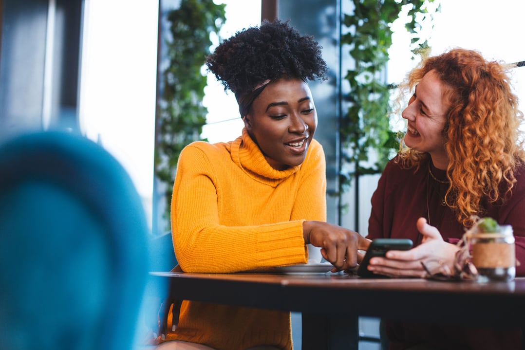 two-women-on-a-phone-talking-with-each-other